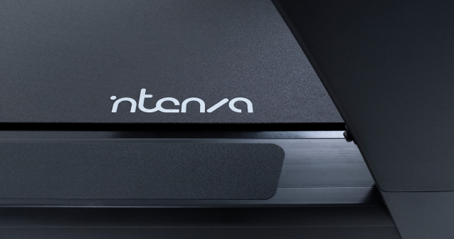 Close-up view of Intensa treadmill showcasing the brand wordmark and sleek modern design details.